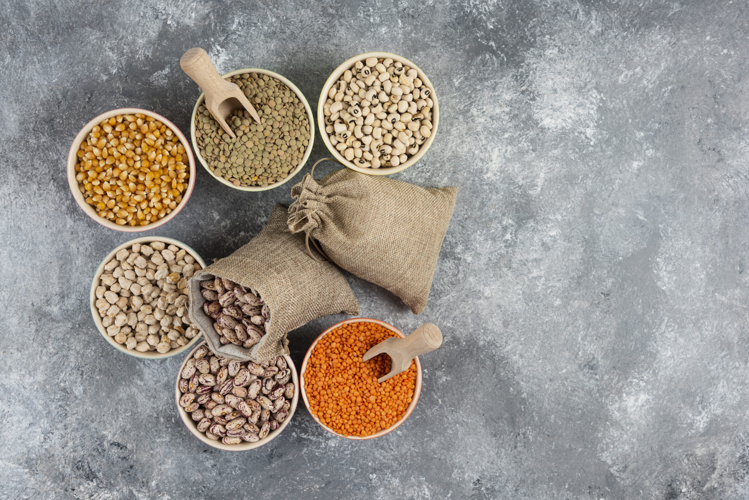 Assortment of raw dry legumes composition on marble surface. High quality photo